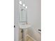 Cozy powder room features a stylish pedestal sink, decorative mirror, and modern lighting at 9255 E Lehigh Ave # 194, Denver, CO 80237
