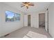 Bright bedroom features a ceiling fan, plush carpet, and closet space at 9255 E Lehigh Ave # 194, Denver, CO 80237