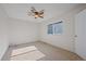 Comfortable bedroom with a ceiling fan, plush carpet, and a large window at 9255 E Lehigh Ave # 194, Denver, CO 80237