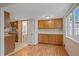 Bright dining area featuring wooden cabinets, hardwood floors, and window at 9255 E Lehigh Ave # 194, Denver, CO 80237