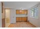 Dining area featuring hardwood floors, built-in cabinets, and convenient access to the half-bathroom at 9255 E Lehigh Ave # 194, Denver, CO 80237