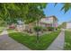 Well-maintained exterior with a green lawn, mature trees, and tidy landscape beds at 9255 E Lehigh Ave # 194, Denver, CO 80237