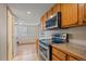 Updated kitchen with stainless steel appliances, modern countertops, and sleek microwave at 9255 E Lehigh Ave # 194, Denver, CO 80237