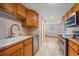 Galley style kitchen features stainless steel appliances, tile backsplash, and an adjacent eating area at 9255 E Lehigh Ave # 194, Denver, CO 80237