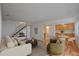 Bright living room featuring hardwood floors, staircase, and modern furnishings at 9255 E Lehigh Ave # 194, Denver, CO 80237