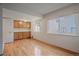 Sunlit living room features sleek hardwood floors and classic wooden built-in cabinetry at 9255 E Lehigh Ave # 194, Denver, CO 80237