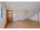 Inviting living room featuring hardwood floors, front door, and stairway to the upper level at 9255 E Lehigh Ave # 194, Denver, CO 80237