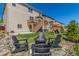 Landscaped backyard featuring a fire pit with Adirondack chairs, a deck, and a playset at 5758 Echo Park Cir, Castle Rock, CO 80104