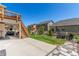 Backyard with a grassy lawn, a playset, a fire pit and a stone patio at 5758 Echo Park Cir, Castle Rock, CO 80104