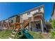Spacious backyard featuring a playset, a deck, a covered patio and well-maintained lawn at 5758 Echo Park Cir, Castle Rock, CO 80104