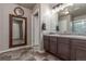 Bathroom featuring a large mirror, stylish tile flooring, and double vanity sinks at 5758 Echo Park Cir, Castle Rock, CO 80104