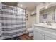 Bathroom featuring a tub with shower, wooden floors, a modern toilet and a stylish vanity at 5758 Echo Park Cir, Castle Rock, CO 80104