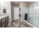 Modern bathroom with a tiled floor, glass shower, and a double vanity for added convenience at 5758 Echo Park Cir, Castle Rock, CO 80104