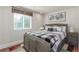 Cozy bedroom featuring a wooden bed frame, black and white bedding and ample natural light at 5758 Echo Park Cir, Castle Rock, CO 80104