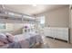 Charming bedroom featuring a bunk bed with a whimsical rainbow quilt and white dresser at 5758 Echo Park Cir, Castle Rock, CO 80104