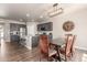 Open-concept kitchen and dining area boasts stainless steel appliances, a granite island, and a rustic wood dining table at 5758 Echo Park Cir, Castle Rock, CO 80104
