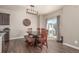 Bright dining room featuring a modern light fixture, rustic wood table, and sliding glass door to the backyard at 5758 Echo Park Cir, Castle Rock, CO 80104