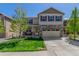 Charming two-story home featuring stone accents, a well-manicured lawn, and a convenient two-car garage at 5758 Echo Park Cir, Castle Rock, CO 80104