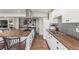 Charming kitchen with a functional layout, featuring white cabinets and wood countertops at 5758 Echo Park Cir, Castle Rock, CO 80104