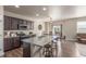 Spacious kitchen featuring granite countertops, an island with seating, stainless steel appliances, and a dining area at 5758 Echo Park Cir, Castle Rock, CO 80104