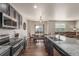 Modern kitchen with stainless steel appliances, granite countertops, a breakfast bar, and an adjacent dining area at 5758 Echo Park Cir, Castle Rock, CO 80104