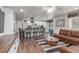 Open concept living area flowing into a kitchen with a cozy brown leather couch at 5758 Echo Park Cir, Castle Rock, CO 80104