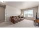 Bright living room with plush carpeting, large window, and comfortable brown couch at 5758 Echo Park Cir, Castle Rock, CO 80104