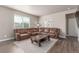 Cozy living room with a large leather sectional, stylish coffee table, and lots of natural light at 5758 Echo Park Cir, Castle Rock, CO 80104