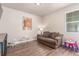 Cozy living room features wood laminate floors, a comfortable couch, and a bright window with natural light at 5758 Echo Park Cir, Castle Rock, CO 80104