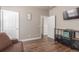 Open-concept living room showcasing wood laminate floors, neutral walls, and a view into the hallway at 5758 Echo Park Cir, Castle Rock, CO 80104