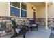 Inviting covered front porch featuring stone accents and comfortable seating at 5758 Echo Park Cir, Castle Rock, CO 80104