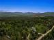Scenic aerial view of the luxury home nestled within a lush mountain landscape at 28532 Hummingbird Hill Rd, Conifer, CO 80433