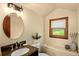Bathroom with granite countertop, oval mirror and exterior views at 28532 Hummingbird Hill Rd, Conifer, CO 80433