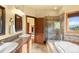 Bathroom with granite countertops, glass enclosed shower and soaking tub at 28532 Hummingbird Hill Rd, Conifer, CO 80433