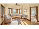 Bright bedroom with bay window seating, hardwood floors and adjacent bathroom entry at 28532 Hummingbird Hill Rd, Conifer, CO 80433