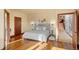 Bedroom with hardwood floors, soft grey color palette and doorway to the stairway at 28532 Hummingbird Hill Rd, Conifer, CO 80433