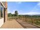 Spacious outdoor deck with wooden railings and scenic mountain views in the distance at 28532 Hummingbird Hill Rd, Conifer, CO 80433