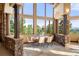 Dining room with stone details and walls of windows offering stunning views of the outdoors at 28532 Hummingbird Hill Rd, Conifer, CO 80433