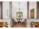 Elegant dining room features rustic wood beams, wood floors, neutral walls and a decorative light fixture at 28532 Hummingbird Hill Rd, Conifer, CO 80433
