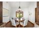 Bright dining room features wood floors, table with seating for six and a decorative chandelier at 28532 Hummingbird Hill Rd, Conifer, CO 80433