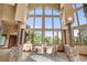 Dining room with stone details and walls of windows offering stunning views of the outdoors at 28532 Hummingbird Hill Rd, Conifer, CO 80433