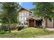 Inviting home exterior featuring natural stone accents and a wall of windows at 28532 Hummingbird Hill Rd, Conifer, CO 80433