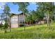 Beautiful exterior of mountain home with striking architectural features and natural landscaping at 28532 Hummingbird Hill Rd, Conifer, CO 80433