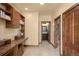Hallway with built-in desk and shelving unit, along with tile flooring at 28532 Hummingbird Hill Rd, Conifer, CO 80433