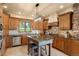 Traditional kitchen with custom wood cabinetry, granite countertops, stainless appliances and a large center island at 28532 Hummingbird Hill Rd, Conifer, CO 80433