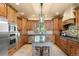 Traditional kitchen with custom wood cabinetry, granite countertops, stainless appliances and a large center island at 28532 Hummingbird Hill Rd, Conifer, CO 80433