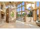 Open-concept living area with floor-to-ceiling windows and stone accent features at 28532 Hummingbird Hill Rd, Conifer, CO 80433