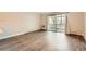 Living room with neutral walls, wood flooring, and sliding glass doors leading to a balcony at 9300 E Center Ave # 3A, Denver, CO 80247