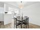 Bright dining area with a modern light fixture and a view into the kitchen at 3450 S Eagle St # 101, Aurora, CO 80014