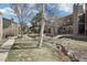 Exterior daytime view of the condo, with a flowing creek and mature birch tree at 3450 S Eagle St # 101, Aurora, CO 80014